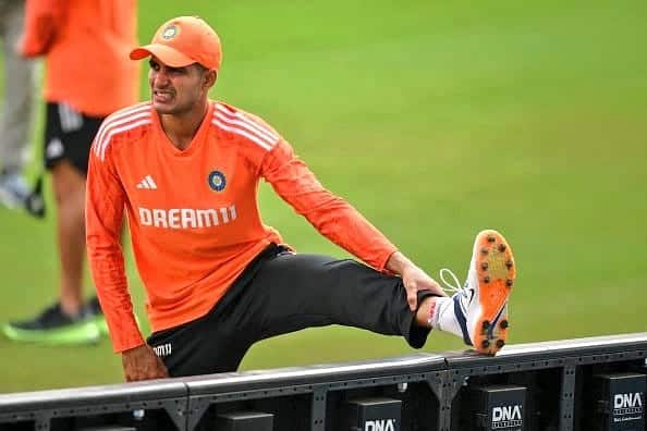 Shubman Gill holds his injured finger while fielding in a practice match before the first Test against Australia.